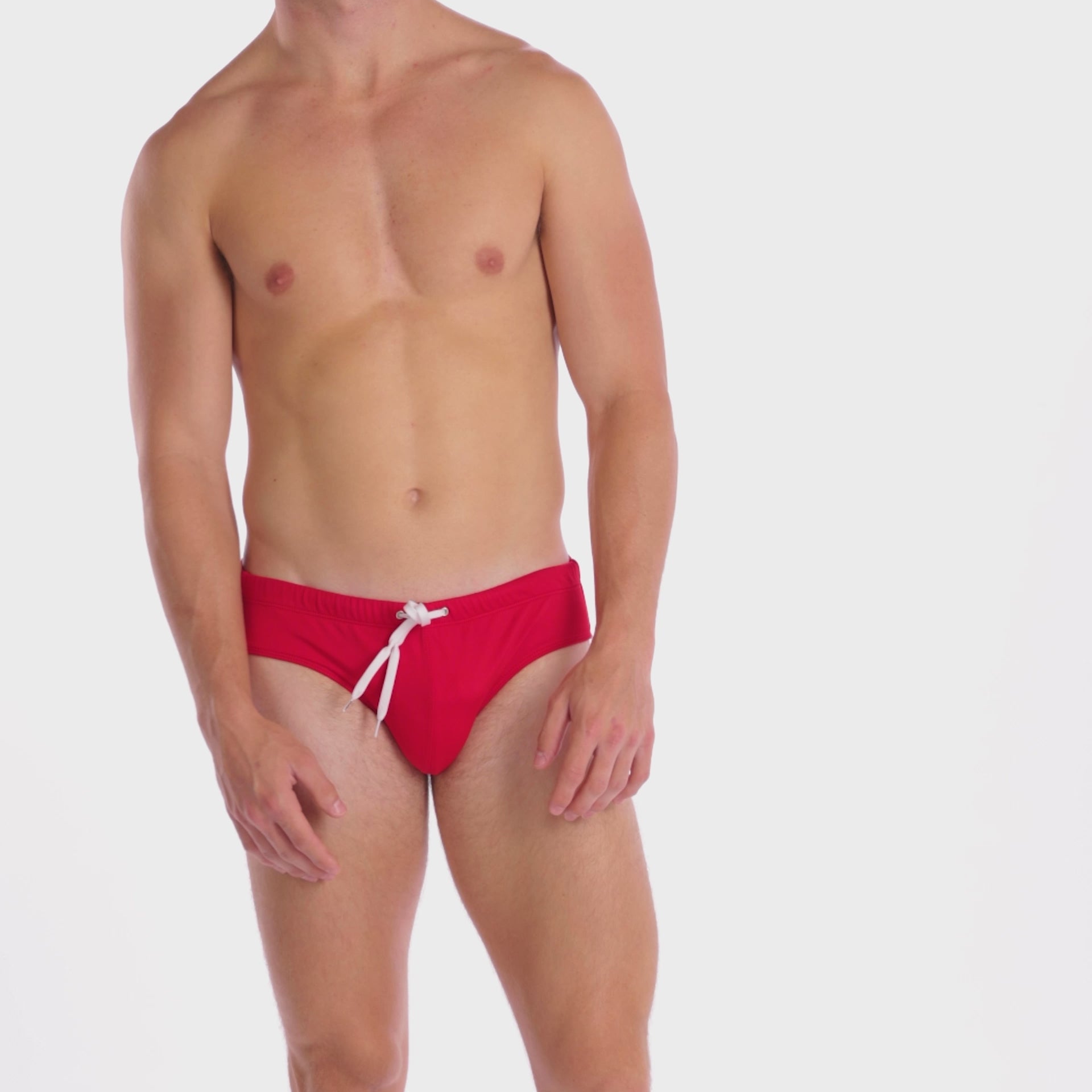 A WHITE WALL VIDEO OF A MALE MODEL WEARING A SAMMY SHOP MEN'S CHERRY ECO SWIM BRIEF