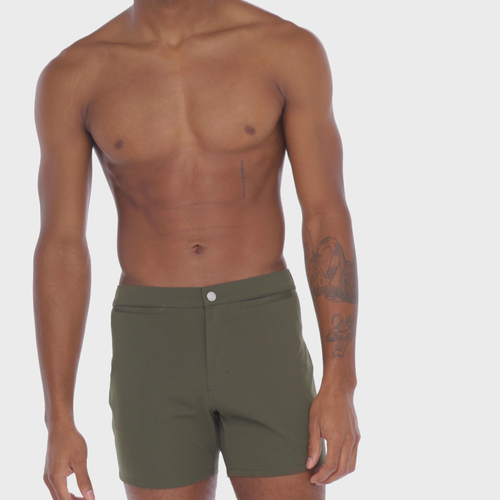 A WHITE WALL VIDEO OF A MALE MODEL WEARING A SAMMY SHOP UNISEX OLIVE VERSATILE SHORT