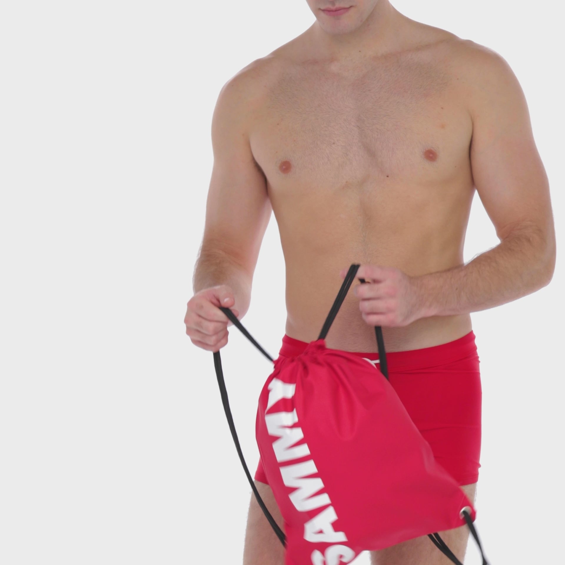 A WHITE WALL IMAGE OF A MALE MODEL WEARING A SAMMY SHOP UNISEX CHERRY ECO SWIM SHORT